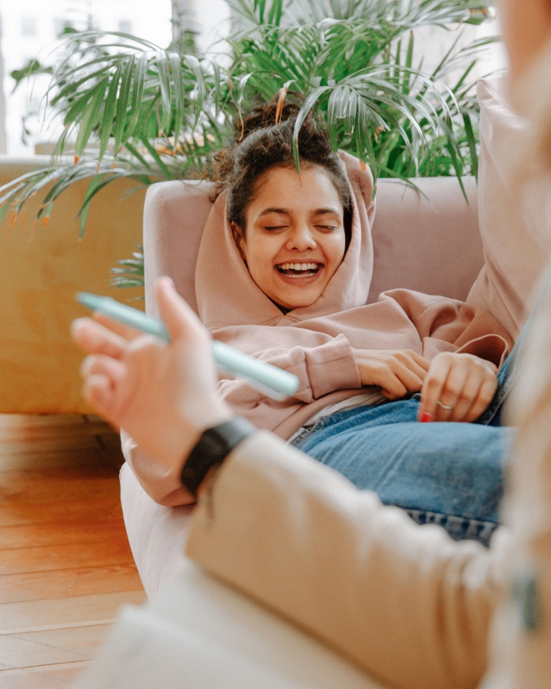 A client laughing during an online therapy session from home in Ontario